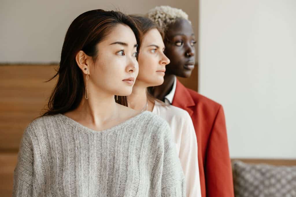 three group of women in different nationalities facing in the same side view